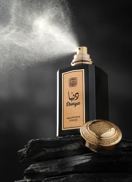 Naseem Dunya Aqua Parfum 100ml black and gold perfume bottle spraying fragrance with luxurious gold cap and elegant presentation