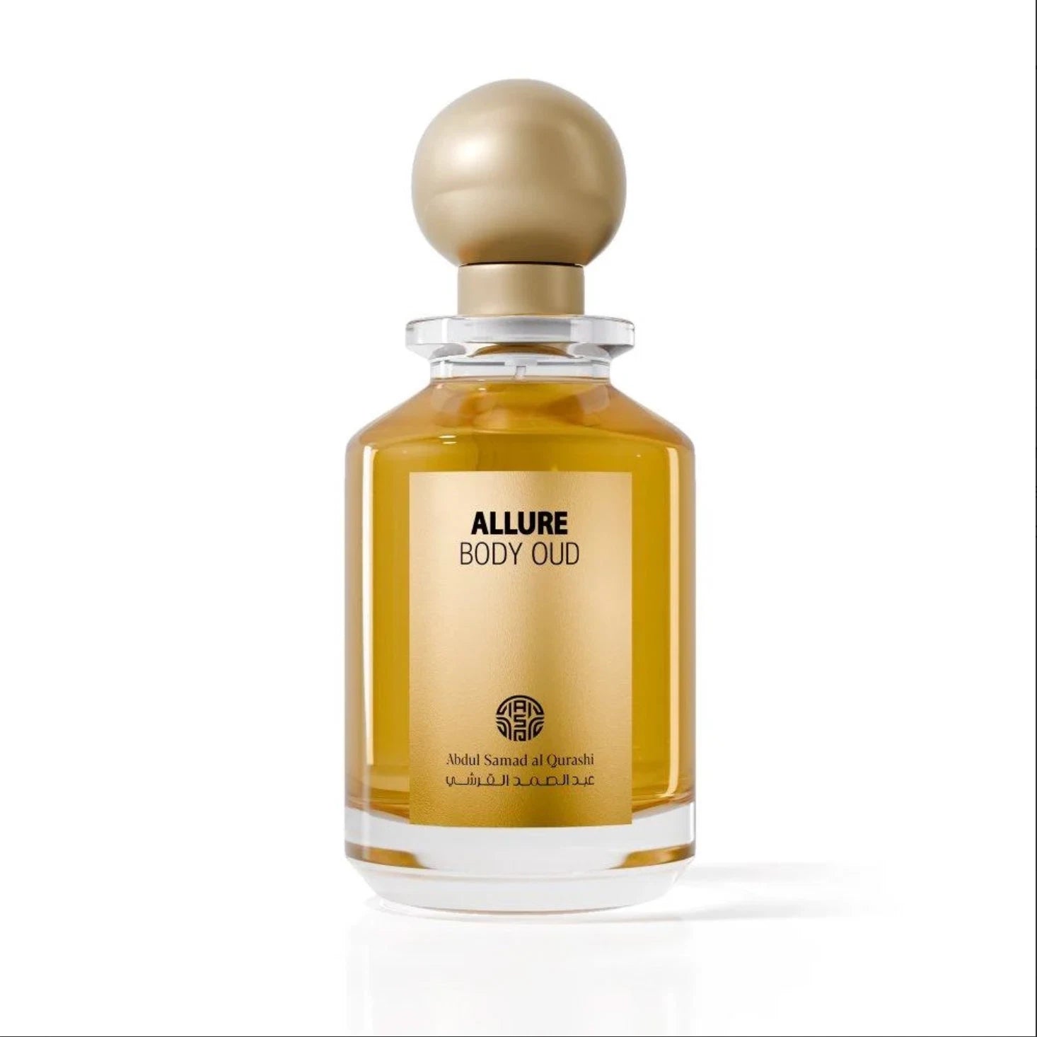 Abdul Samad Al Qurashi Allure Body Oud 100ml parfum bottle filled with golden amber fragrance oil, featuring a gold label and a spherical gold cap on a white background.
