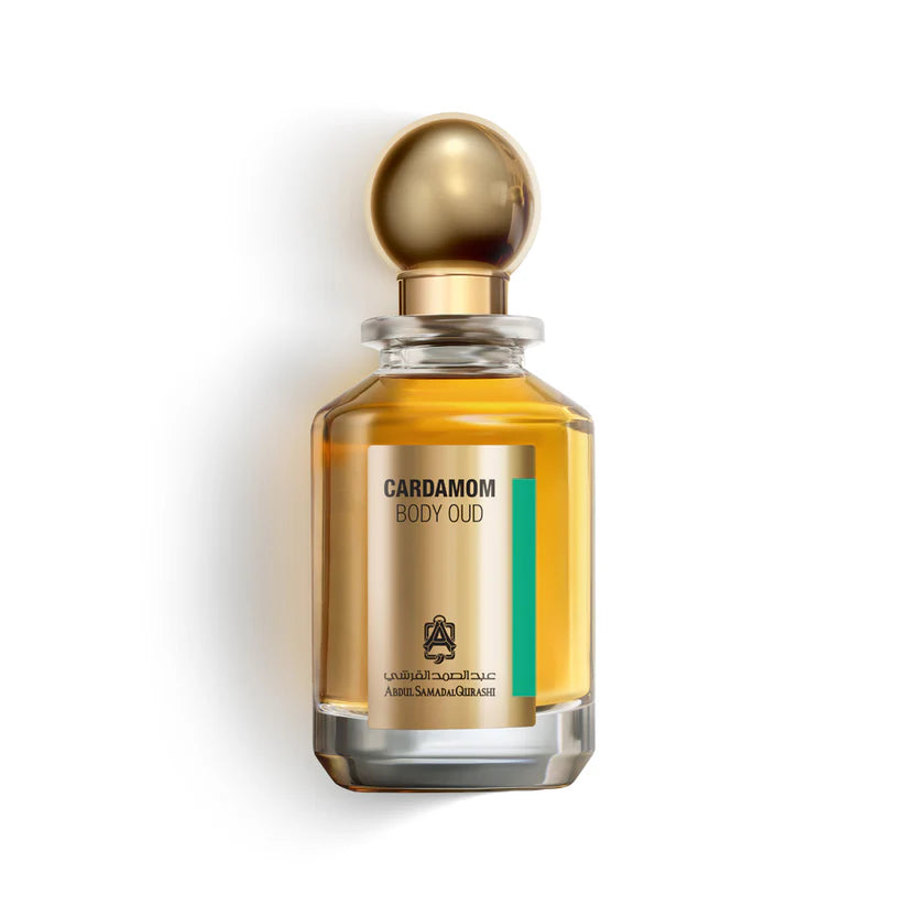 Abdul Samad Al Qurashi Cardamom Body Oud 100ml parfum bottle filled with golden amber liquid, featuring a metallic gold spherical cap against a white background.