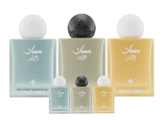 Large and small sizes of blue, green, and yellow Ibraheem Al Qurashi Musk perfume bottles.