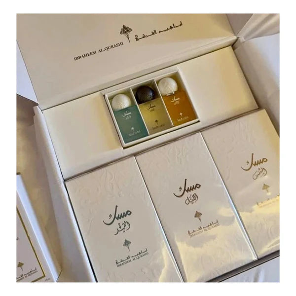 Open white luxury gift box containing the Ibraheem Al Qurashi Musk perfume collection.
