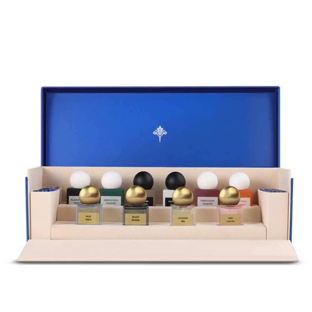 Open blue box of the Ibraq Discovery Diamond perfume collection showing various mini sample bottles.