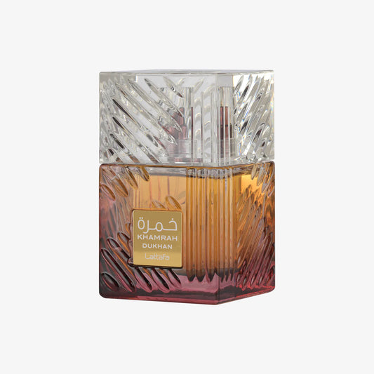 Lattafa Khamrah Dukhan 100ml parfum bottle featuring a crystal-clear textured cap and a heavy glass base with an amber-to-burgundy gradient, centered against a solid white background.